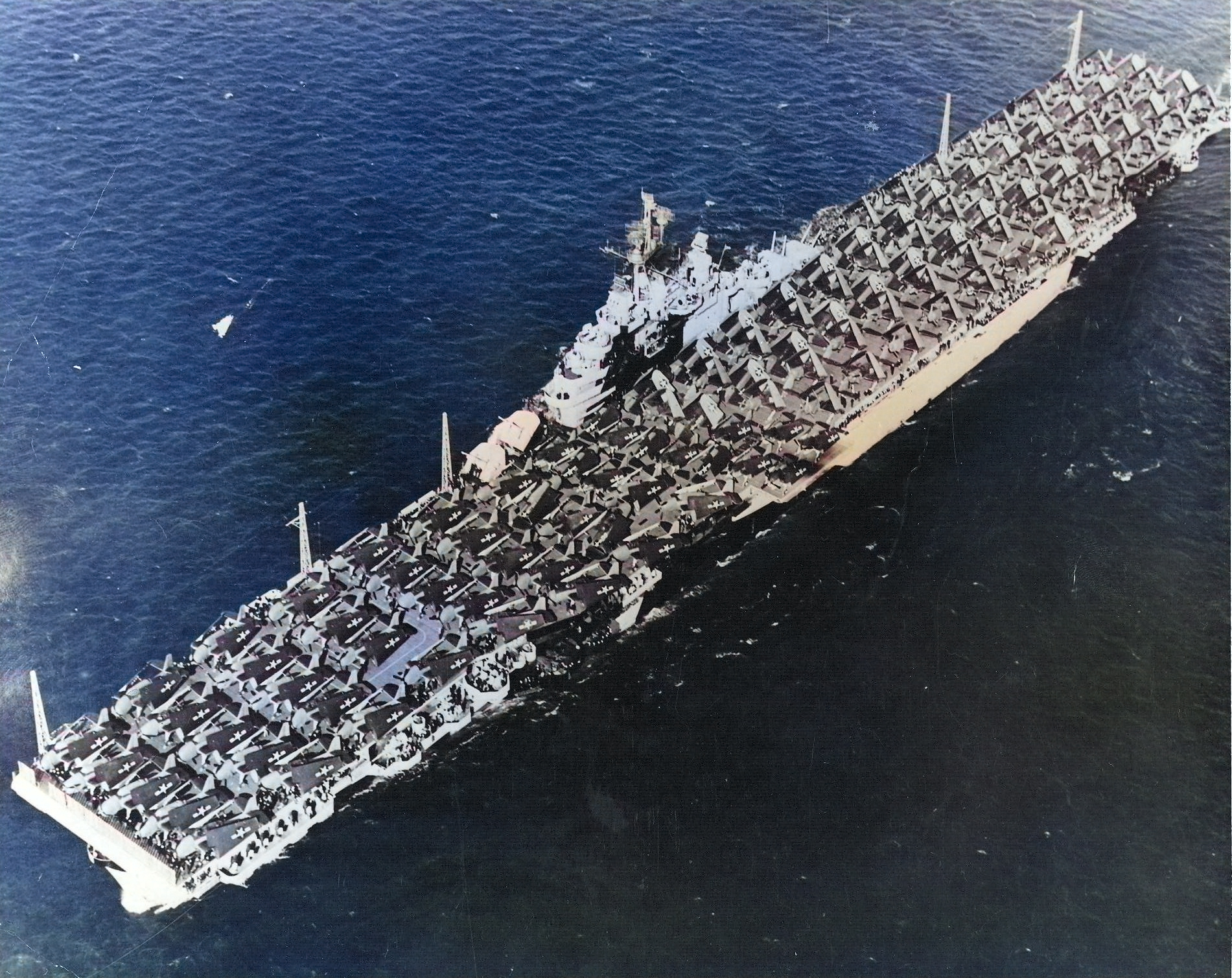 USS Essex departing San Francisco Naval Shipyard, California, United States, 15 Apr 1944, photo 4 of 4; note camouflage measure 32 design 6/10D [Colorized by WW2DB]