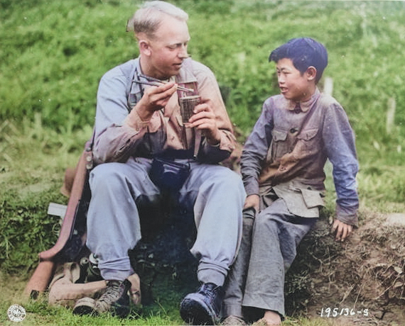 US Army Signal Corps photographer Private Arthur W. Hedgo with Chinese boy Lee Ting Yow, northern Burma, 6 May 1944 [Colorized by WW2DB]