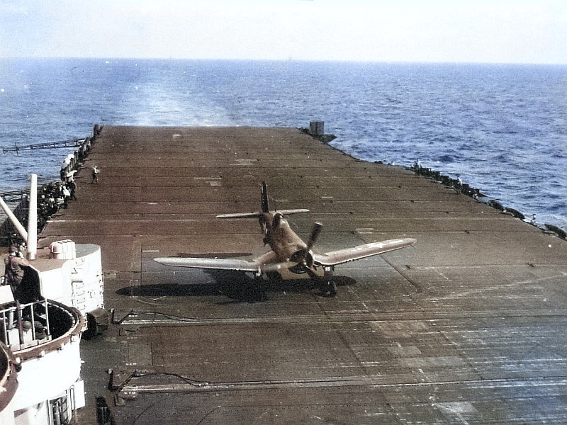 F4U Corsair at the barrier wires after landing aboard USS Bennington around Okinawa in the Western Pacific, Apr 1945. [Colorized by WW2DB]