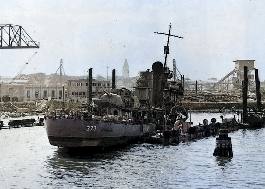 Destroyer USS Shaw with her bow blown off and settled in the sunken floating drydock YFD-2 in Pearl Harbor, Hawaii, mid-Dec 1941. Photo 2 of 2. [Colorized by WW2DB]