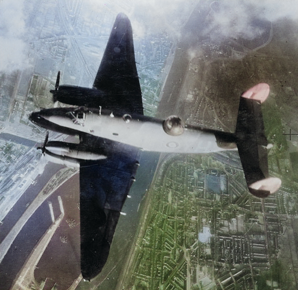 British RAF Ventura bomber over IJmuiden Steelworks, IJmuiden, the Netherlands, Feb 1943; as seen in US Navy publication Naval Aviation News dated 15 Sep 1943 [Colorized by WW2DB]