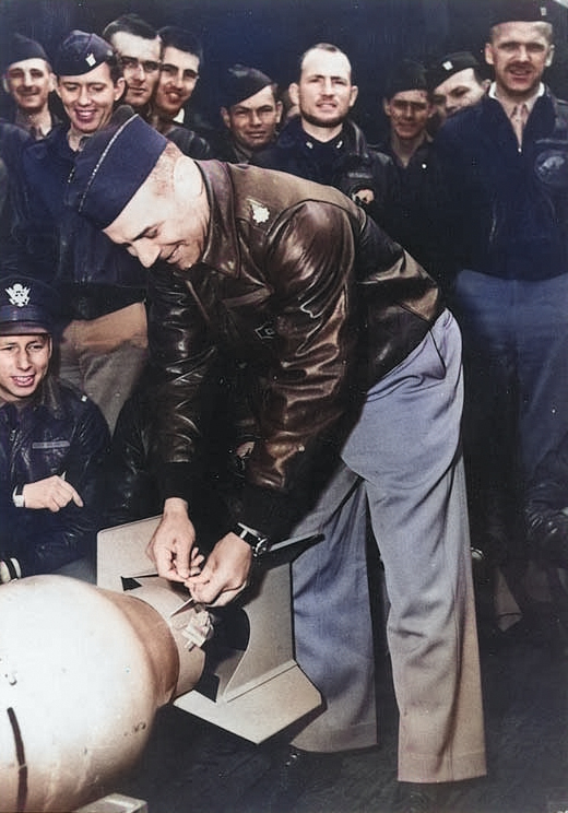 Doolittle wiring a Japanese medal to a bomb, Apr 1942, 1 of 2 [Colorized by WW2DB]