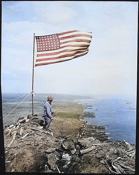 American flag atop Mount Suribachi, Iwo Jima, Japan, Feb 1945 [Colorized by WW2DB]