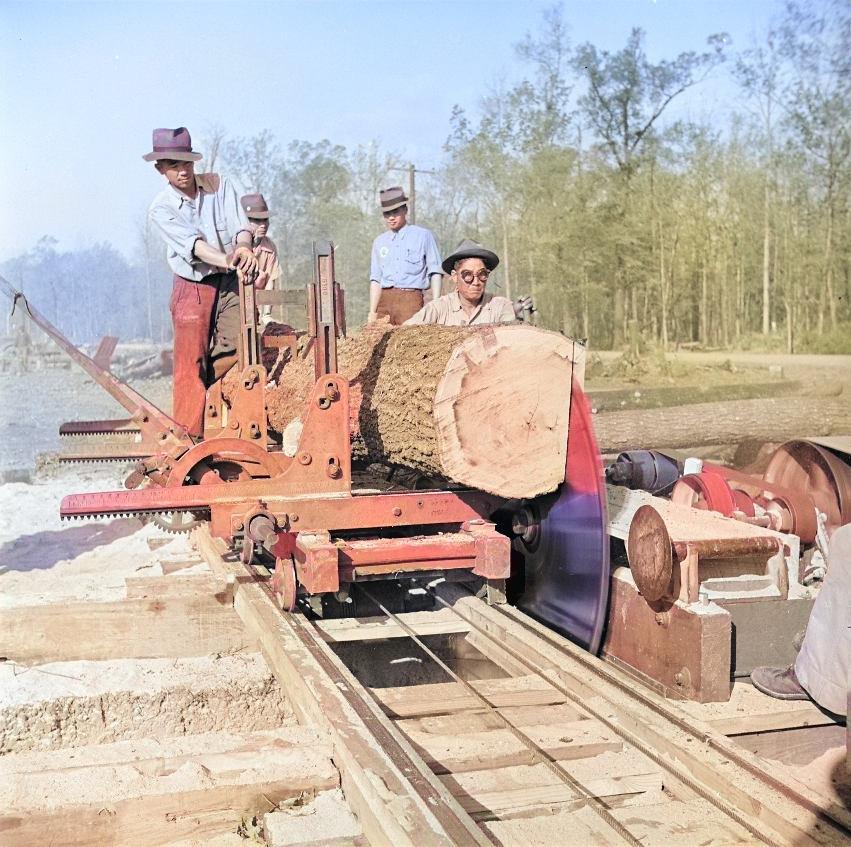 Men working at a saw mill, Jerome War Relocation Center, Arkansas, United States, 16 Nov 1942, photo 1 of 2 [Colorized by WW2DB]
