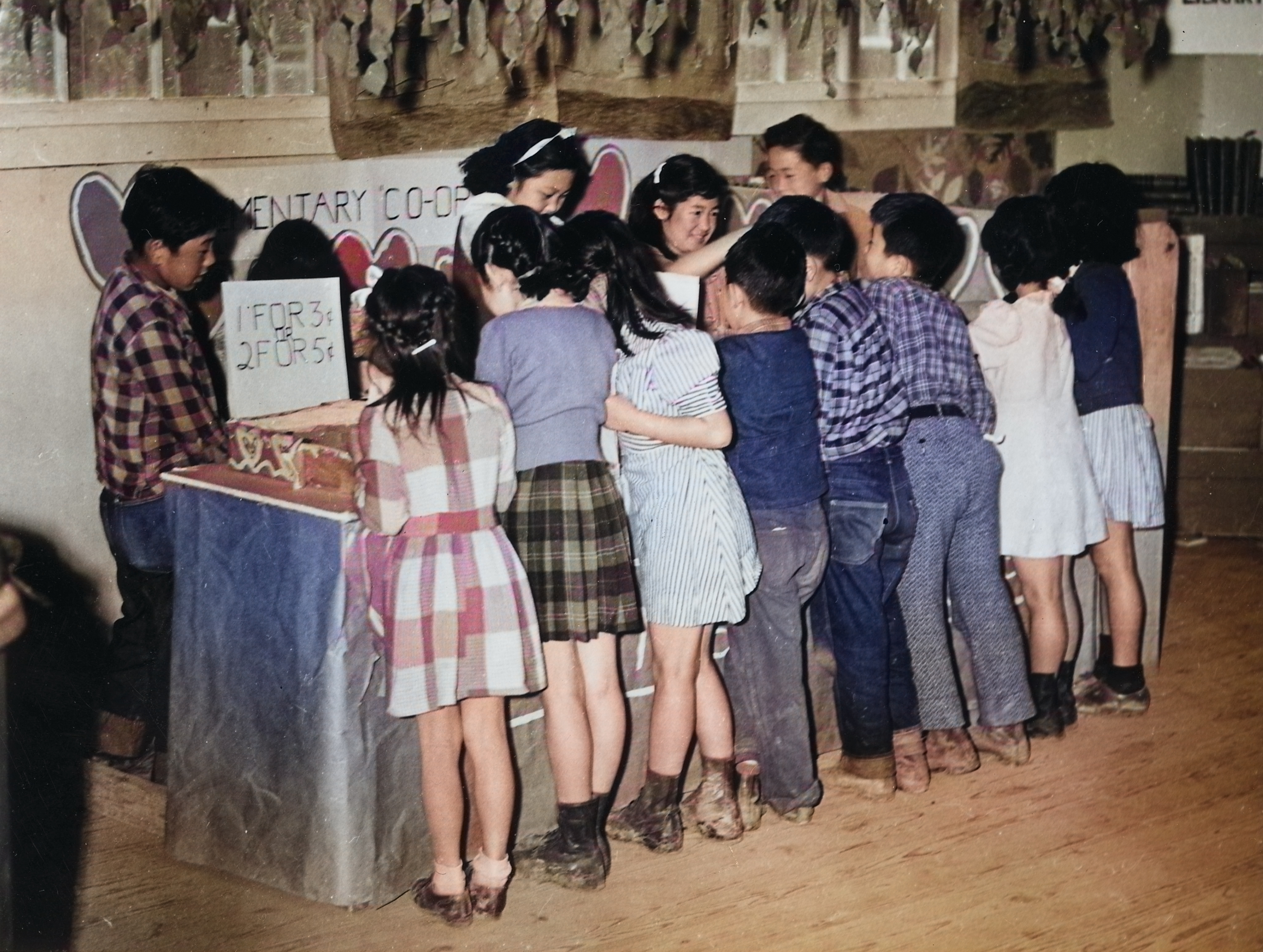 Fourth grade Japanese-American children at a cooperative store stand selling valentines, Jerome War Relocation Center, Arkansas, United States, Feb 1944, photo 1 of 3 [Colorized by WW2DB]