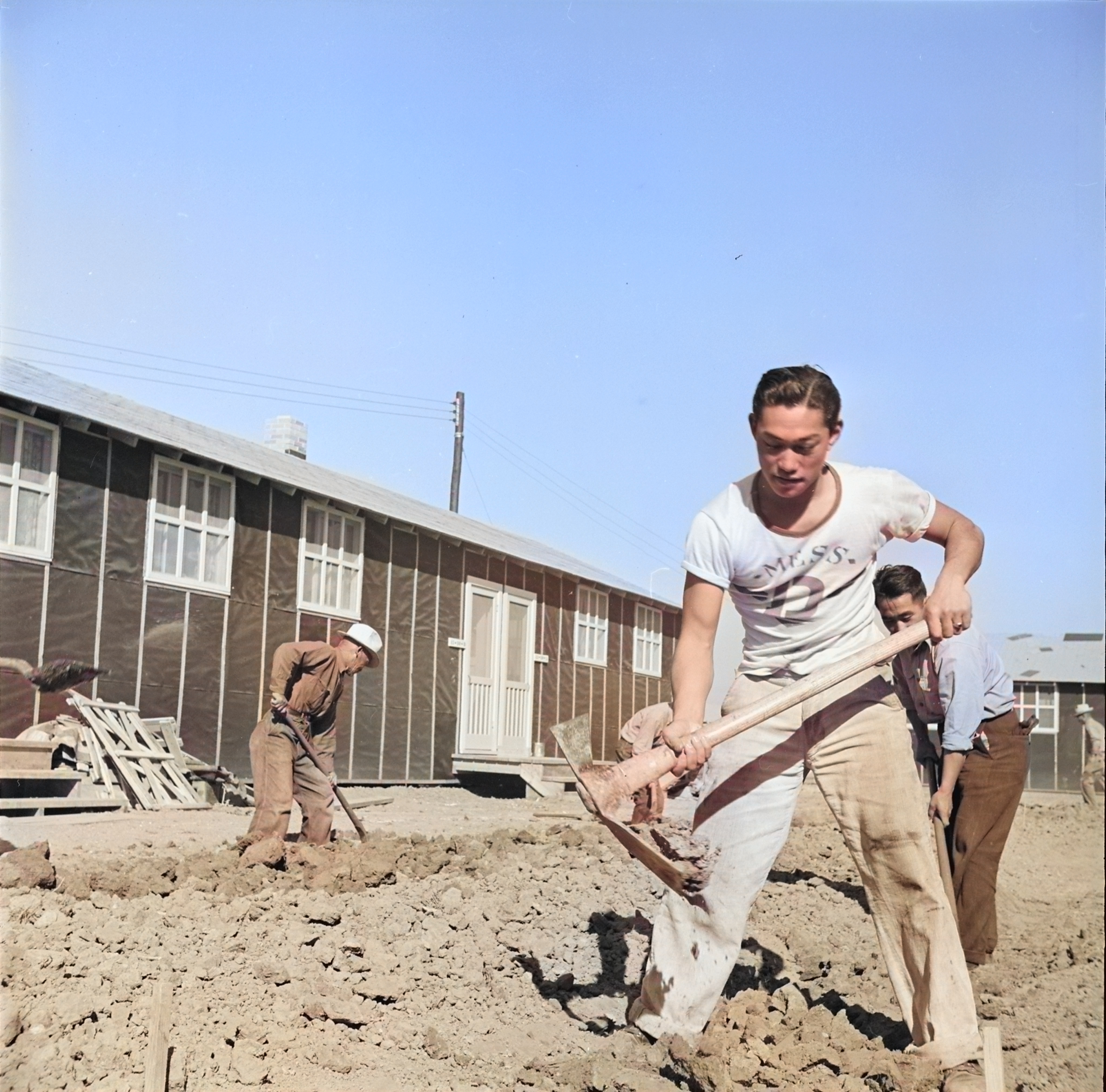 Men digging drainage ditches between barracks buildings, Jerome War Relocation Center, Arkansas, United States, 17 Nov 1942 [Colorized by WW2DB]