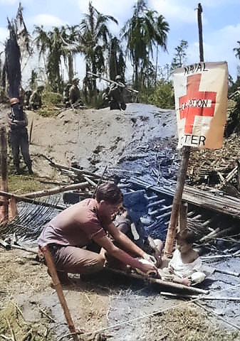 A Filipino woman being treated at an US Navy first aid station, Leyte, Philippine Islands, 20 Oct 1944 [Colorized by WW2DB]