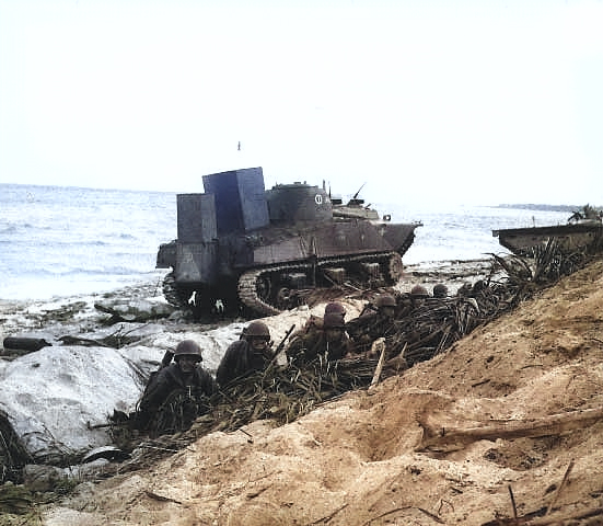 US Army troops waiting on the invasion beach on Kwajalein, 1 Feb 1944 [Colorized by WW2DB]