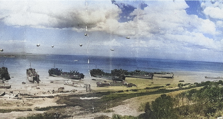 LSTs unloading at low tide in the Easy sector of Omaha Beach, Normandy, 28 Jun 1944, photo 2 of 2; note wrecked LCI(L) in the center [Colorized by WW2DB]