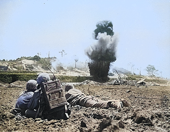 US Army observers calling in artillery fire against a Japanese position on Okinawa, Japan, circa Apr-Jun 1945 [Colorized by WW2DB]