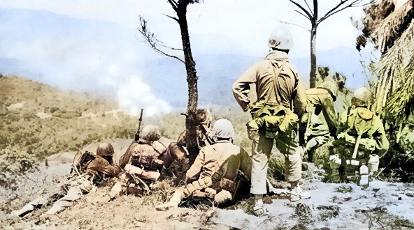 Men of the US 6th Marine Division observing shelling of a Japanese position near Yae Take Airfield, Okinawa, Japan, 14 Apr 1945 [Colorized by WW2DB]