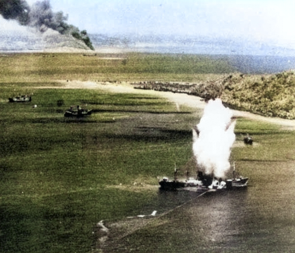 Japanese freighter at Truk, Caroline Islands hit by a torpedo dropped from a US Navy squadron VT-10 Avenger aircraft, 17 Feb 1944, photo 1 of 2 [Colorized by WW2DB]