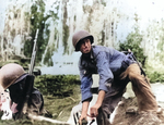 United States Marine preparing to throw a Mark II “pineapple” grenade on Guadalcanal, Solomon Islands, 1942. Note Browning Automatic Rifle at left.