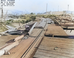 View from the demolished pier looking toward shore and more flattened buildings following a munitions explosion at Port Chicago, California, United States, 17 Jul 1944. 18 Jul 1944 photo.