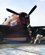 Crewmen pull through the prop of Grumman F6F-5 Hellcat “10,000th Hellcat” BuNo 78854 of Fighting-Bombing Squadron VBF-87 aboard USS Ticonderoga, May-Jun 1945 in the western Pacific.