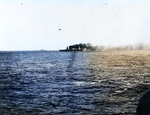 Lexington afire and down at the bow but still steaming and operating aircraft, shortly after she was hit by Japanese torpedoes and bombs during the Battle of Coral Sea, about noon on 8 May 1942