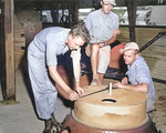 US personnel checking an atomic bomb casing, Tinian, Mariana Islands, 1945