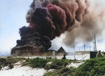 Oil tanks burning on Sand Island of Midway Atoll after Japanese attack, 4 Jun 1942