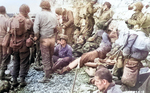 Men of 3rd Battalion, 16th Infantry Regiment, US 1st Infantry Division, resting at the beach at Omaha Beach near Colville-Sur-Mer, Normandy, France, 8 Jun 1944