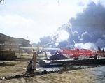 View of Naval Air Station Ford Island, Oahu, US Territory of Hawaii, 7 Dec 1941; note USS Shaw (exploding) and USS Nevada; PBY, OS2U, and SOC aircraft