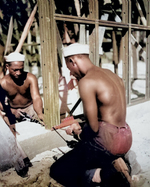 African-American men of US 34th Construction Battalion constructing prefabricated steel warehouse at Halavo Seaplane Base, Florida Island, Solomon Islands, 19 Sep 1943