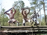 Three African-American United States Marine Corps recruits running the obstacle course at Camp Lejeune of Montford Point Camp, North Carolina, United States, Apr 1943