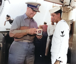 Admiral Arleigh Burke and a Third Class Quartermaster on bridge of destroyer Picking, circa 1955-1961