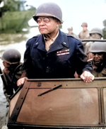 African-American US Army Brigadier General Benjamin O. Davis, Sr. watching a Signal Corps crew erecting poles, France, 8 Aug 1944