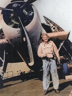 Lieutenant R. S. Evarts posing with a TBF Avenger aircraft aboard USS Coral Sea, 30 Oct 1943