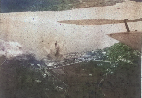 Rising Sun Petroleum Company facilities and nearby military seaplane base at Tamsui, Taiwan under attack by aircraft from USS Intrepid, 12 Oct 1944, photo 2 of 3 [Colorized by WW2DB]