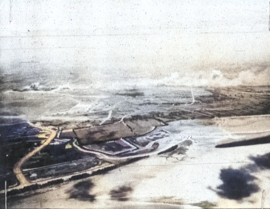 Shinchiku Airfield under US Navy carrier aircraft attack, Taiwan, 13 Oct 1944, photo 2 of 2 [Colorized by WW2DB]