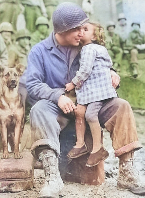 US Army Signal Corp Photo Tec-4 Elvin Harley getting a kiss from a French child while listening to the US 9th Armored Division Band near Aboncourt, France, 14 Feb 1945 [Colorized by WW2DB]