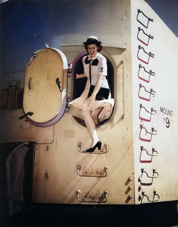 WAVES Yeoman Third Class Betty Martin exiting the rear door of a 5in twin gun turret aboard Missouri, Norfolk Navy Yard, Virginia, United States, during her shakedown period, 19 Aug 1944 [Colorized by WW2DB]