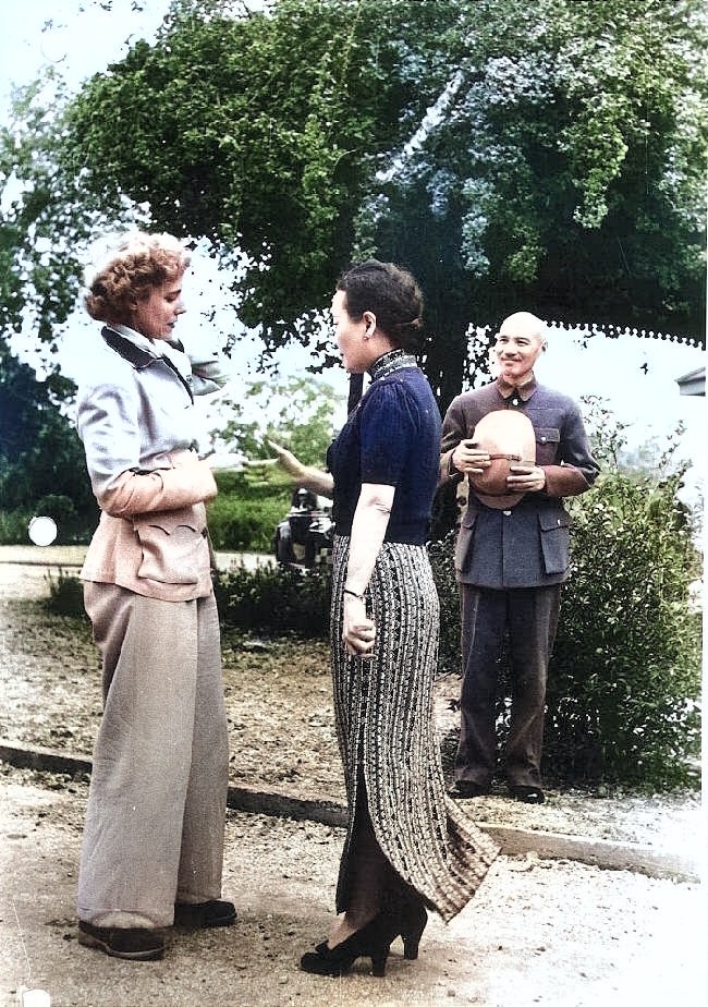Song Meiling welcoming journalist Clare Boothe Luce, Maymyo, Burma, 19 Apr 1942; Chiang Kaishek in background [Colorized by WW2DB]