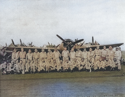 Group portrait of airmen with a FM-1 Wildcat fighter aboard USS Coral Sea, 30 Oct 1943 [Colorized by WW2DB]