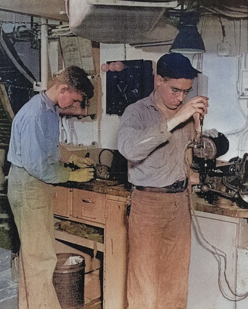 Electrician's Mate 1st Class Reichman and Electrician's Mate 3rd Class Schneider repairing electric fans aboard USS Anzio, 12 Apr 1945 [Colorized by WW2DB]