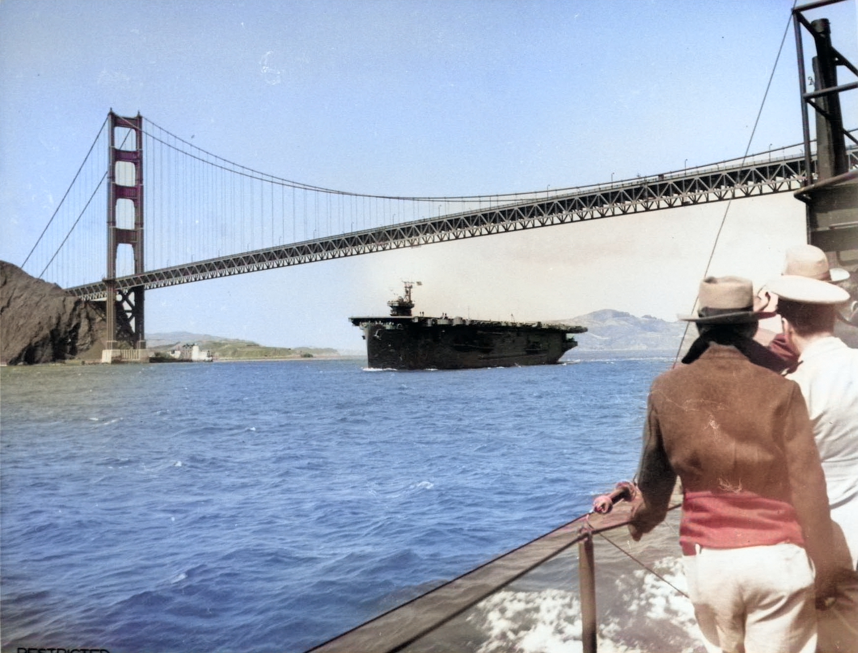 USS Copahee passing under the Golden Gate Bridge, San Francisco Bay, California, United States, 15 Jul 1943 [Colorized by WW2DB]