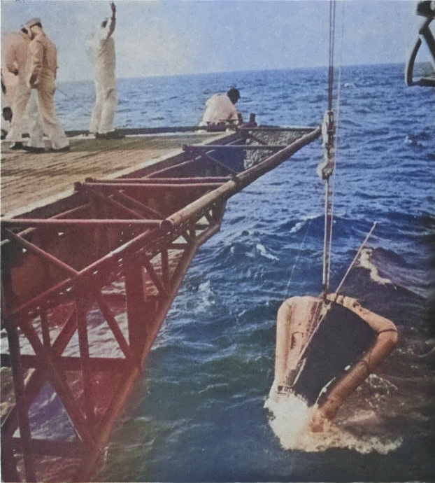 Gemini 3 spacecraft being hoisted aboard USS Intrepid during recovery, in the Atlantic Ocean north of the Dominican Republic, 23 Mar 1965, photo 2 of 2 [Colorized by WW2DB]