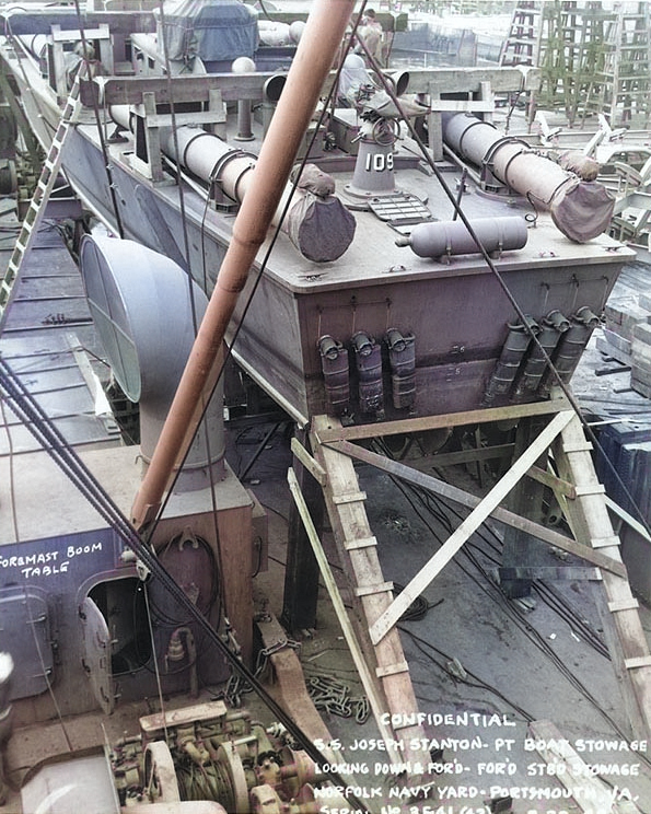 PT-109 stowed on board the Liberty Ship Joseph Stanton for transportation to the Pacific Ocean, Norfolk Navy Yard, Virginia, United States, 20 Aug 1942, photo 2 of 2 [Colorized by WW2DB]