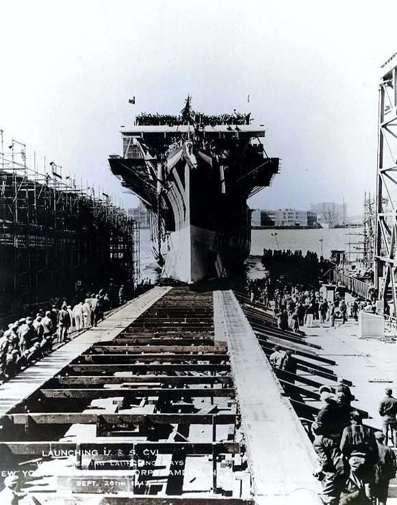 San Jacinto sliding down the building ways at Camden, New Jersey, United States after she was christened by Mrs. Jesse H. Jones, 26 Sep 1943 [Colorized by WW2DB]