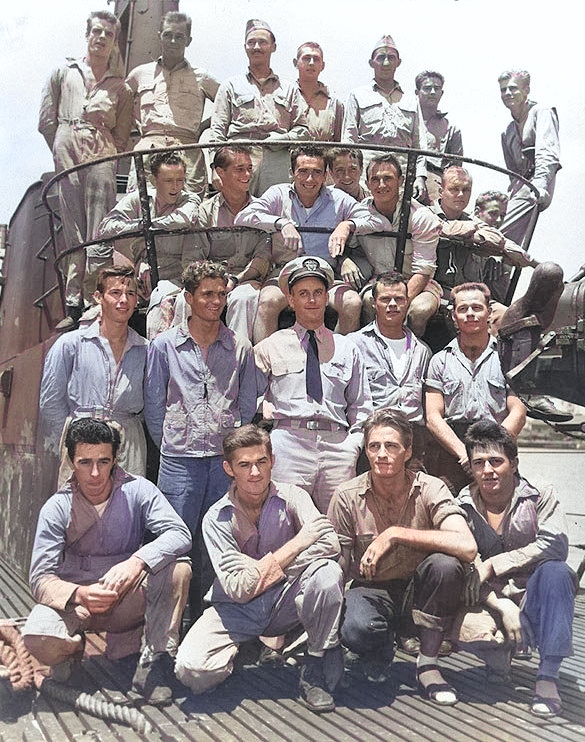 Lieutenant Commander Richard O'Kane posing with 22 airmen rescued by USS Tang near Truk, Caroline Islands between 29 Apr and 1 May 1944; photo taken at Pearl Harbor in May 1944 [Colorized by WW2DB]