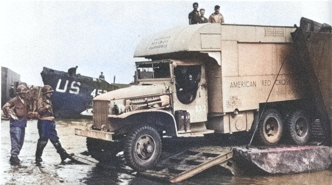 CCKW 2 1/2-ton 6x6 of the American Red Cross exiting landing craft during the Normandy campaign, France, 1944 [Colorized by WW2DB]