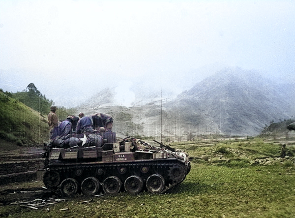 A M19 Twin 40mm Gun Motor Carriage firing at a Chinese position in Korea, date unknown [Colorized by WW2DB]