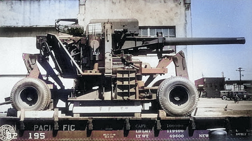 120 mm Gun M1 anti-aircraft weapon of US 85th Antiaircraft Artillery Gun Battalion loaded onto a rail flat car at Norfolk Army Base, Norfolk, Virginia, United States, 10 Apr 1944 [Colorized by WW2DB]