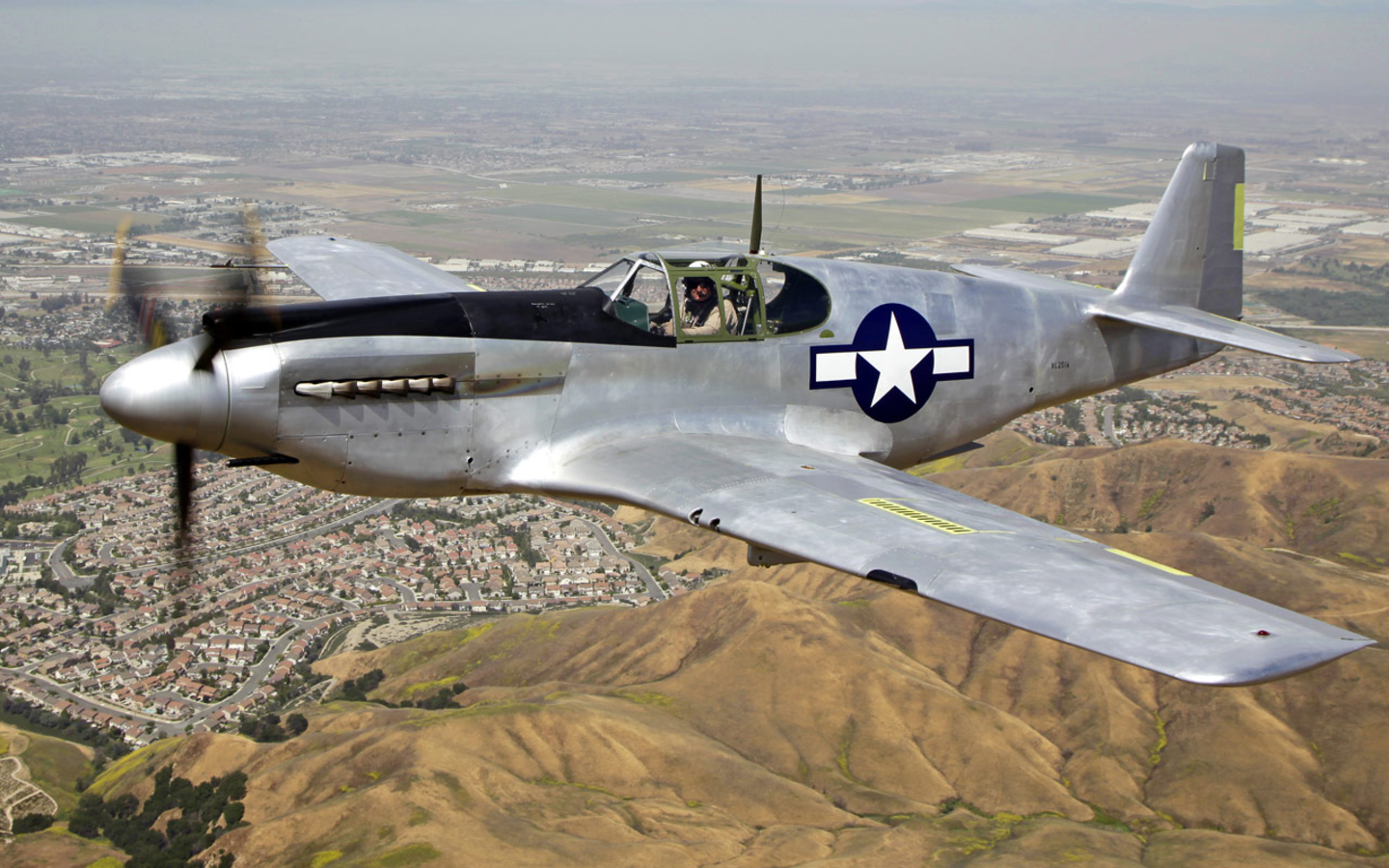 A restored North American A-36A Mustang aircraft in flight, post-war; note 'chin' guns and closed dive brakes