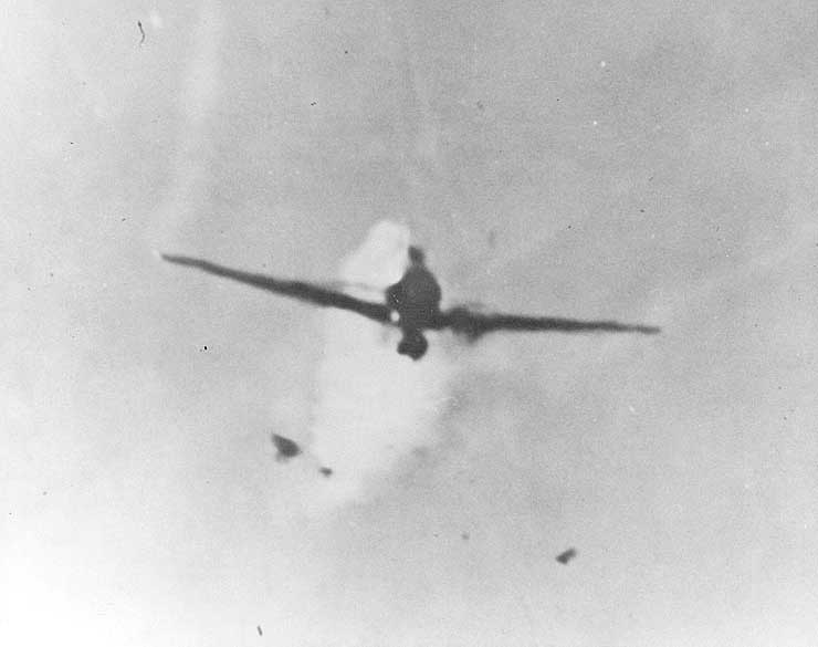 Japanese Zero special attack aircraft, already burning from anti-aircraft fire, diving on USS Columbia during the Lingayen Gulf operation in the Philippine Islands, 6 Jan 1945