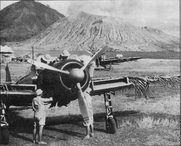 An A6M2 Type 21 'Zero' fighter at Rabaul with the Hanabuki volcano as background, circa 1942-1944