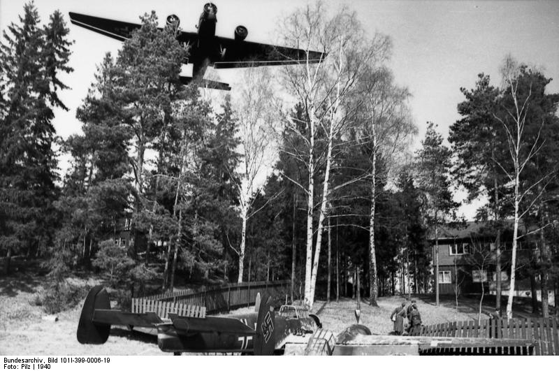 German Ju 52 aircraft flying over the crash site of a German Bf 110 fighter, near Oslo and Fornebu, Norway, 1940