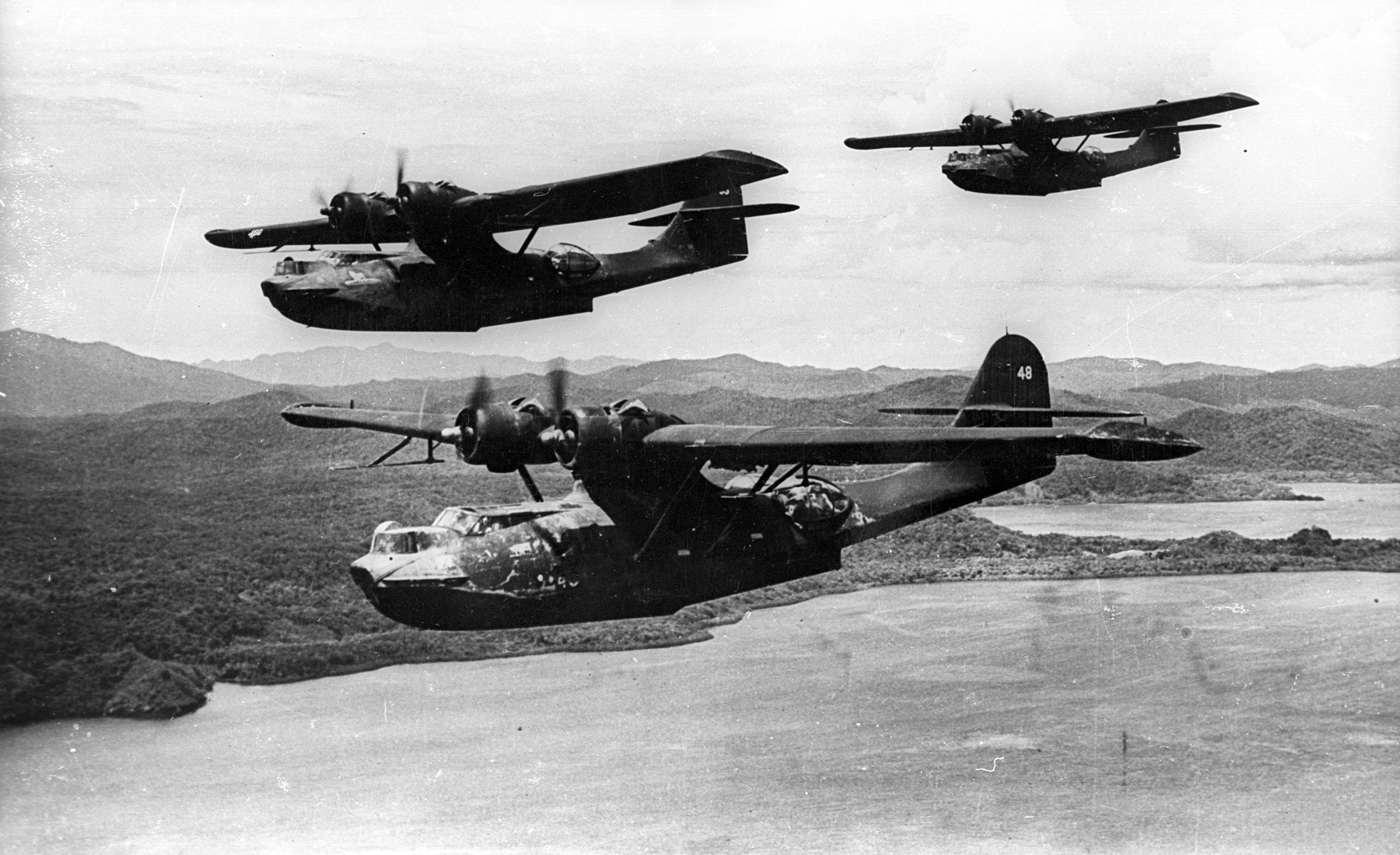 Three US Navy PBY-5A Catalina aircraft of VP-52 in flight in the southwest Pacific, Dec 1943