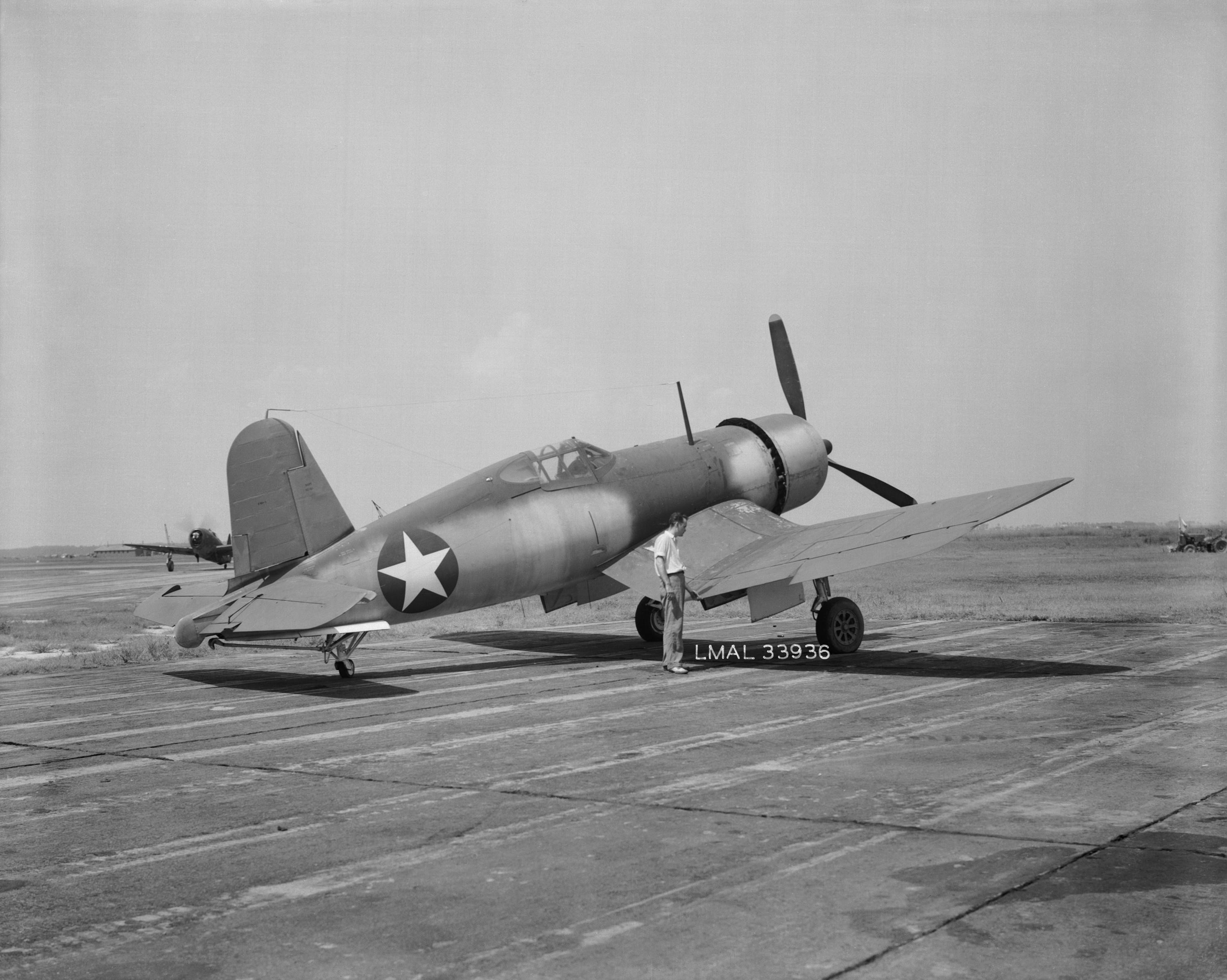 F4U-1 Corsair fighter at Langley Research Center at Hampton, Virginia, United States, 31 Jul 1943. Note the P-47 Thunderbolt on the taxi way behind the Corsair's tail.